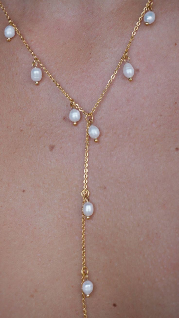 Nothing is quite as graceful as a pearl necklace. Pearl jewelry exudes class and elegance. This lariat style drop pearl necklace makes the perfect centerpiece of all your favorite outfits. Dainty chains along with dainty freshwater pearls. 18k Gold Plated Stainless Steel Chain Imitation pearl Quality: Waterproof, Hypoallergenic, Tarnish Free 100% Eco-Friendly; No Nickel, Chromium and Lead Elegant Lariat Necklace With Pearl Drop, Elegant Long Drop Lariat Necklace With Pearl, Elegant Pearl Charm Dangle Lariat Necklace, Elegant Pearl Charm Lariat Necklace With Dangle, Elegant Lariat Necklace With Pearl Charm Dangle, Elegant Pearl Charm Lariat Necklace, Elegant Long Drop Necklaces With Pearl Chain, Gold Drop Necklace With Pearl For Party, Delicate Lariat Drop Necklace With Pearl