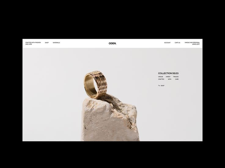 a gold wedding ring sitting on top of a rock in front of a white background