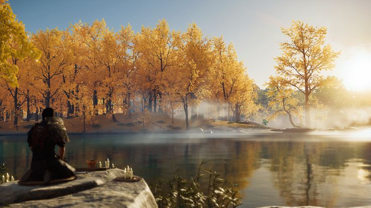 two people sitting on rocks near a lake with trees in the background and steam rising from the water