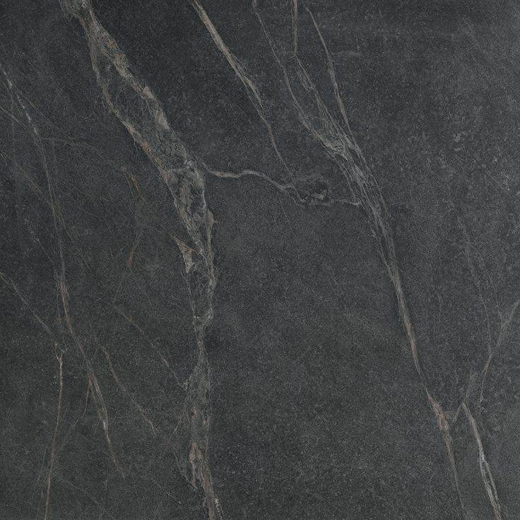 a black marble textured surface with grey veining