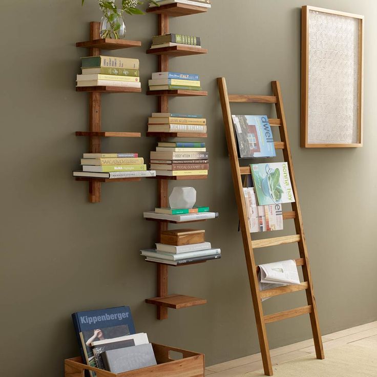 a ladder leaning against a wall next to a book shelf with several books on it