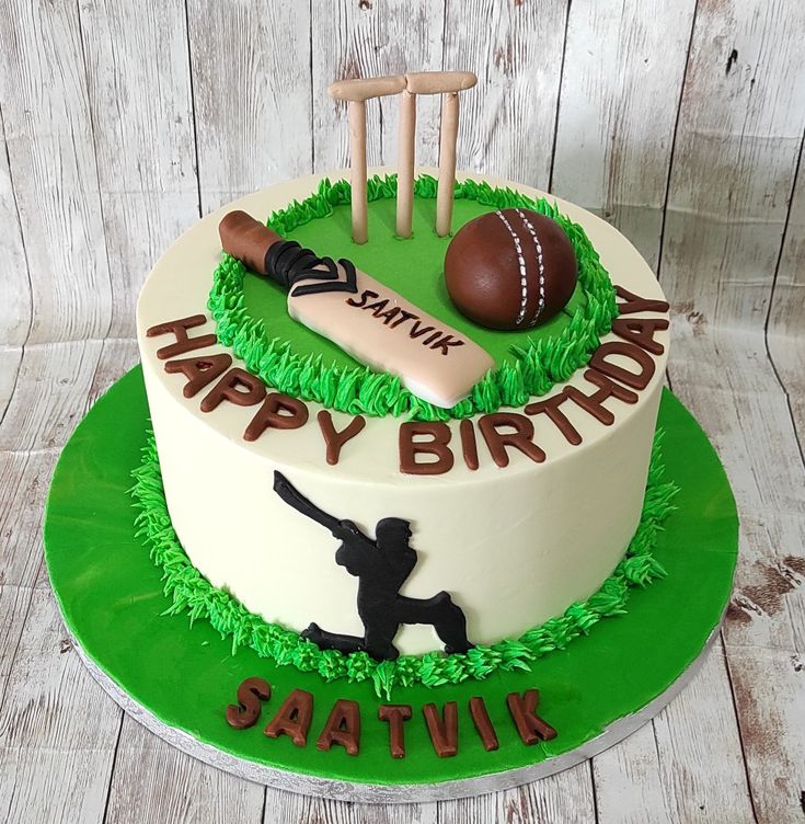 a birthday cake with a cricket theme on the side and a bat, ball, and glove