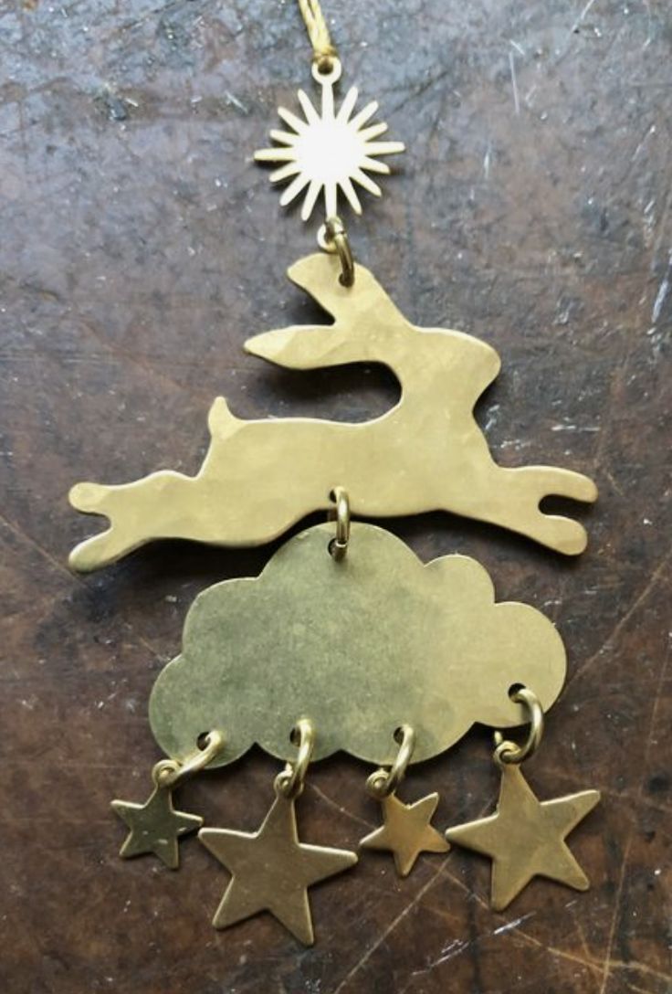 two metal ornaments with stars hanging from them