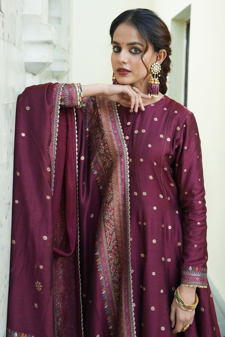 Burgundy maroon long anarkali with woven floral motifs scattered all-over and a thick border on the hem and sleeve hems. Comes with co-ordinating straight pant with a border on the hem and woven motifs dupatta.
Component: 3
Pattern: Woven
Type Of Work: Floral Motifs
Neckline: Round
Sleeve Type: Full
Fabric: Vegan Silk; Lining: Shantoon
Color: Maroon
Other Details: 
Dupatta with scattered floral woven motifs and thick border
Scallop trim on the hem
Show button detail on the concealed front placke Long Anarkali, Types Of Work, Luxury Sale, Scallop Trim, Floral Motifs, Straight Pants, Set For Women, Festival Wear, Anarkali