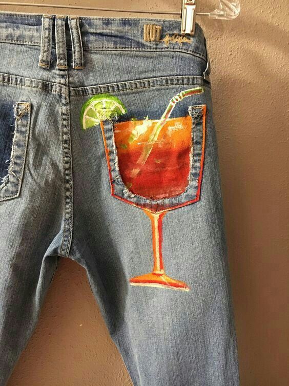 a pair of jeans with an image of a cocktail in the back pocket and a lime slice sticking out of it