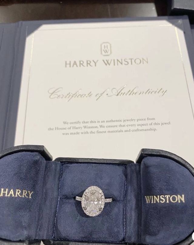 an engagement ring sits in its presentation box