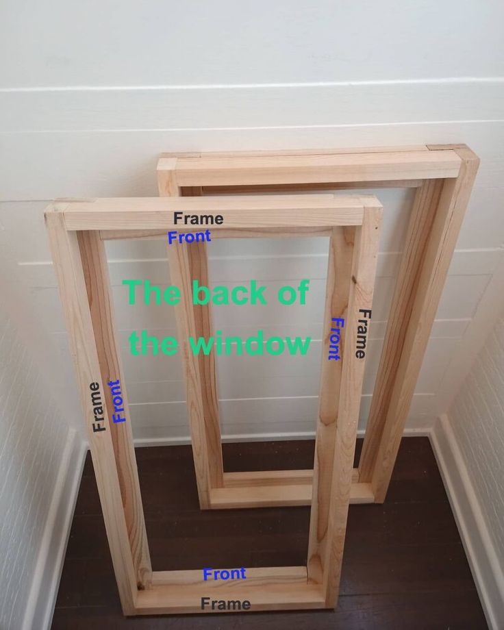 three wooden frames sitting next to each other on top of a hard wood floor in front of a white wall