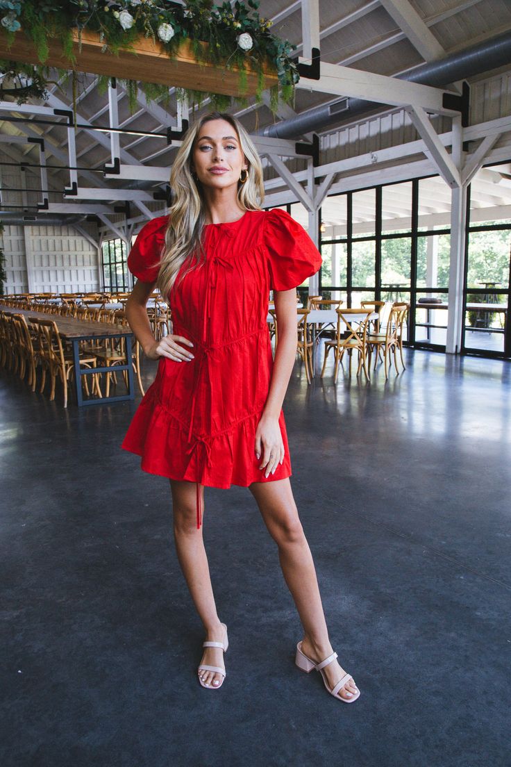 Be the center of attention in our Veronica Puff Sleeve Dress! Its tiered design and bows add a playful touch to the classic red dress. Perfect for any event, this dress will have you feeling confident and stylish. General Info: 100% Cotton Dry Clean Only Puff Sleeves Tiered Bow Details Back Zipper Closure Fit Guide: Measured from size Small Length: 32" from back neckline to hem Shape & Fit: Loose, Relaxed Fabric Elasticity: No Stretch Fabric Texture: Woven Model Info: Height: 5’8” | Bust: 30.5” Chic Red Tiered Dress, Chic Red Tiered Mini Dress, Spring Red Puff Sleeve Dress With Ruffles, Red Tiered Mini Dress For Spring, Red Puff Sleeve Dress With Ruffles, Classic Red Dress, Feeling Confident, Puff Sleeve Dress, Puffed Sleeves Dress