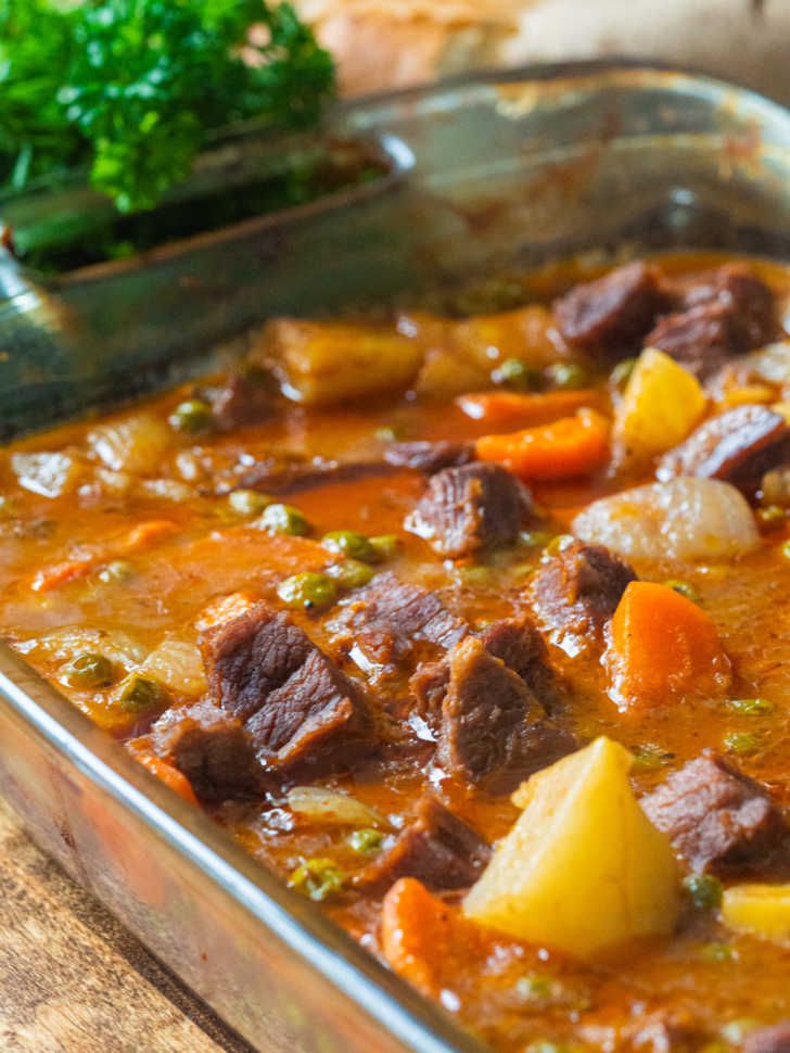 a metal pan filled with stew and vegetables