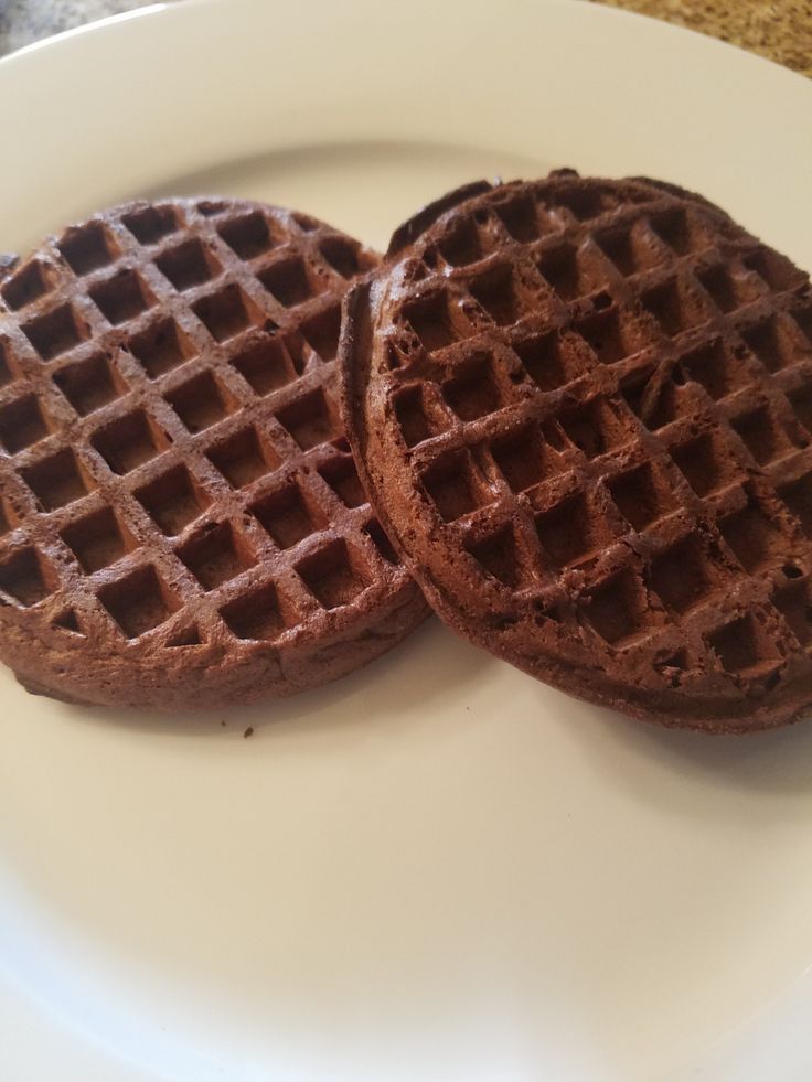 two chocolate waffles on a white plate