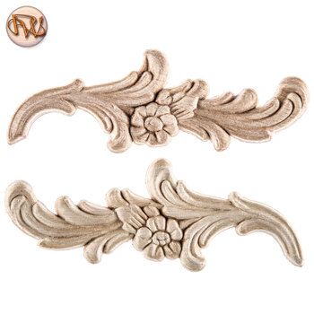 two antique style wood carvings on a white background