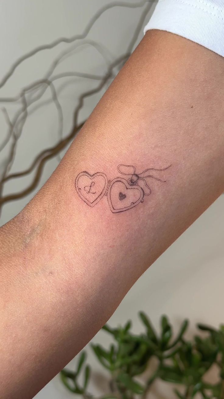 two hearts tattoo on the arm