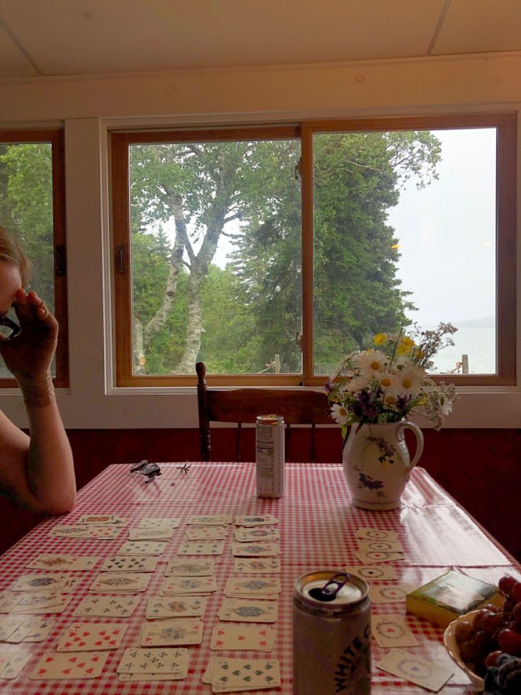 a woman sitting at a table talking on the phone