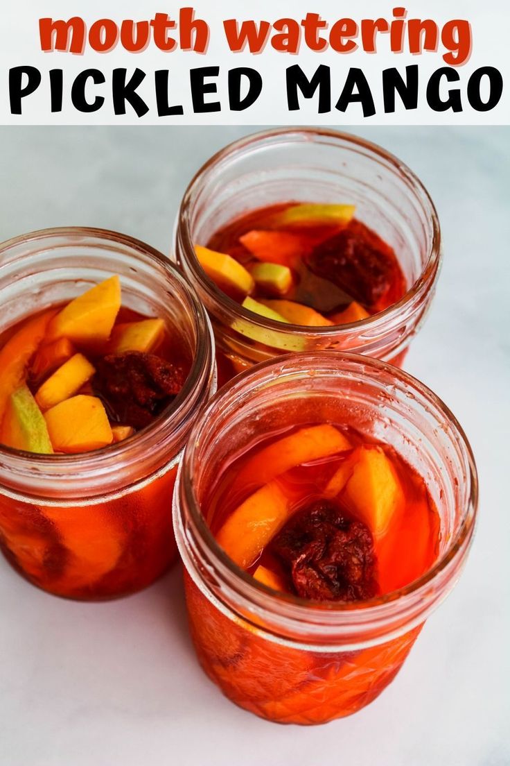 three jars filled with pickled mangos on top of a white counter next to the words mouth watering pickled mango