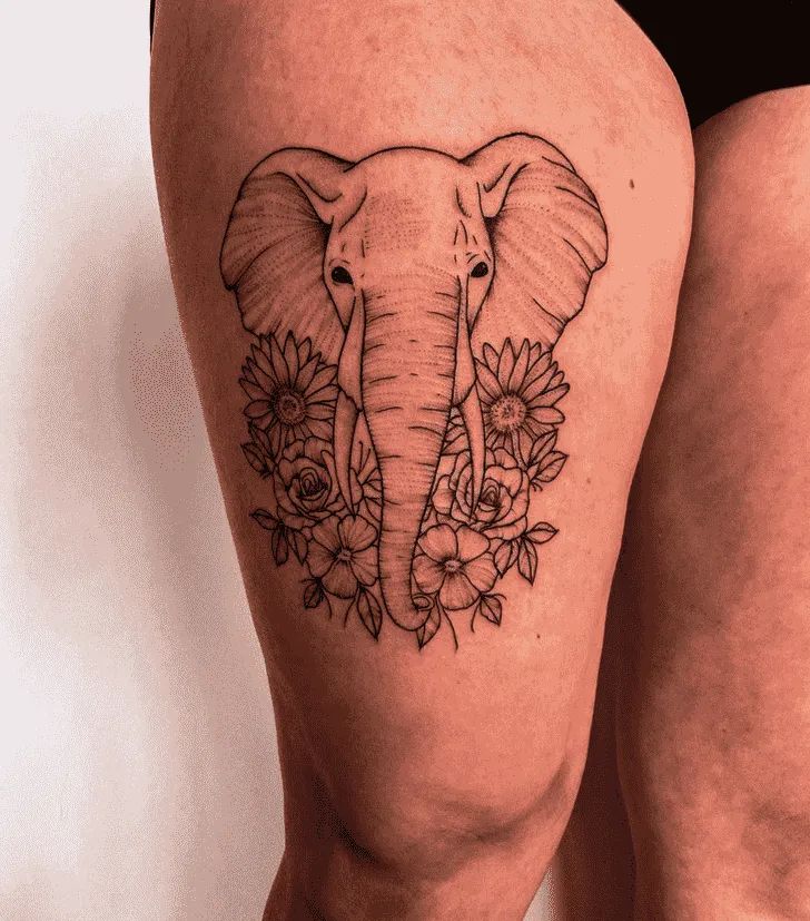 an elephant and flowers tattoo on the thigh, with one side of the leg showing