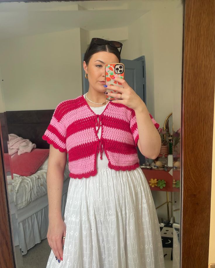 a woman taking a selfie in front of a mirror