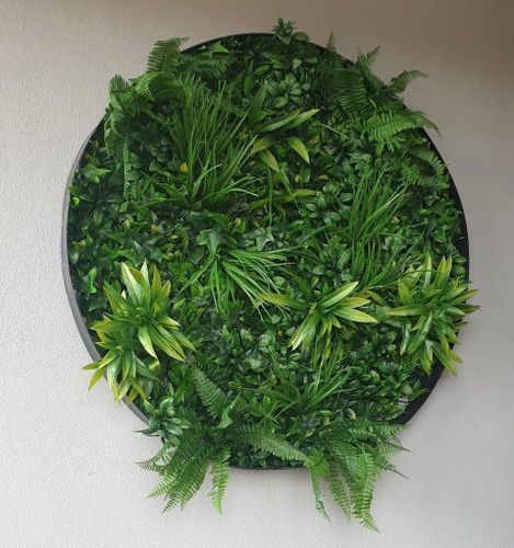 a circular planter with green plants on it