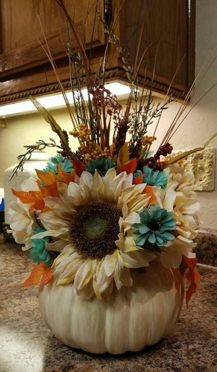 a vase filled with flowers sitting on top of a counter