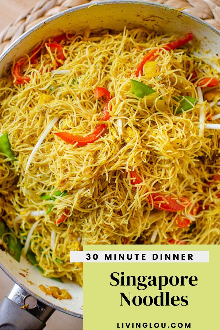 a pan filled with noodles and vegetables on top of a table