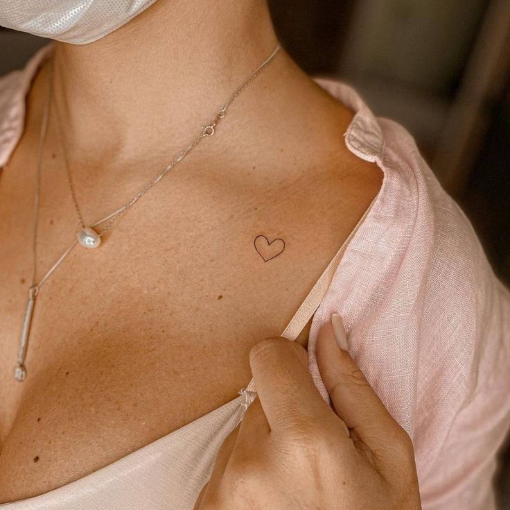 a woman with a heart tattoo on her chest