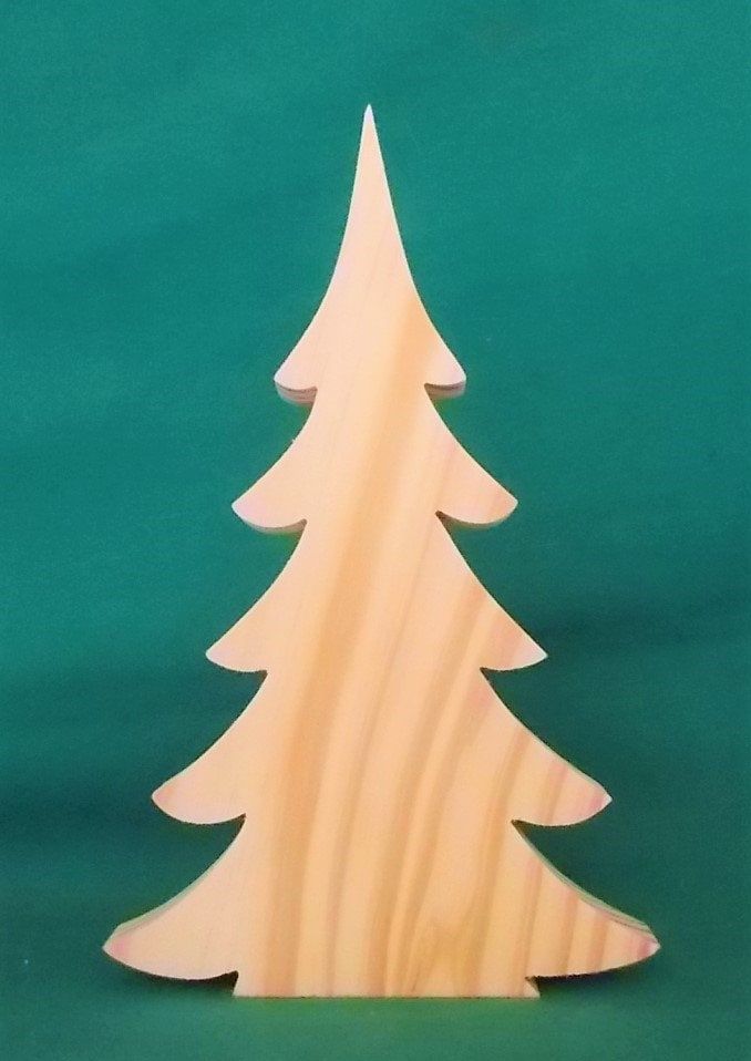 a wooden christmas tree on a green background