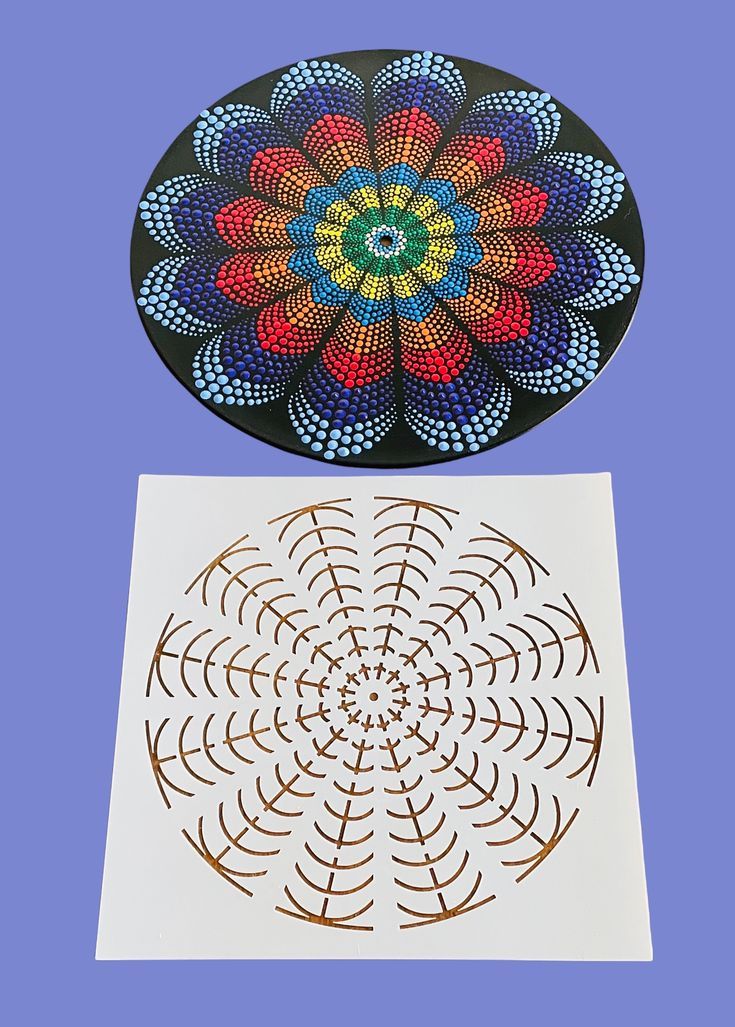 two plates with designs on them sitting next to each other in front of a blue background