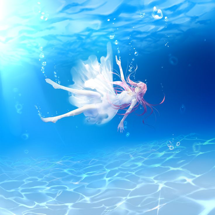 a woman floating in the water with her arms outstretched and legs spread out as she swims