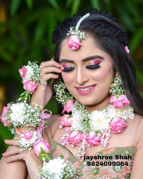 a woman with flowers in her hair and make - up is posing for the camera