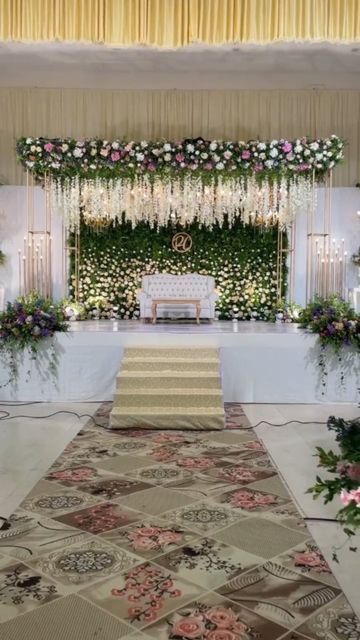 an aisle decorated with flowers and greenery