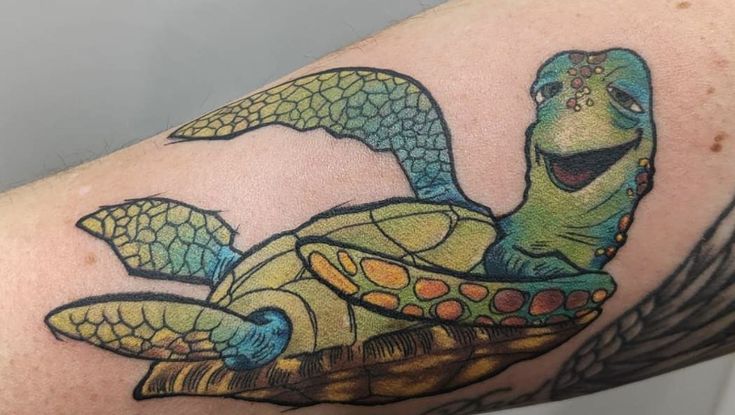 a tattoo with a turtle on it's arm