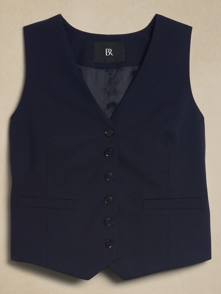 A tailored suit vest, this piece is crafted from our signature Siena Italian wool, selected for its all-weather weight and hint of stretch.  Semi-fitted Fabric sourced from Italy's Marzotto Mill.  V-neck with button-front closure.  Adjustable tabs at waist.  Front pockets.  Fully lined.  Semi-fitted.  Sleeveless.  Above-hip length.  Body length (size S): Regular 21" Model: Size S, 5'10" (178cm). Slim Fit Sleeveless Workwear Vest, Classic Suits With Vest For Work, Fitted Vest Outerwear For Office, Fitted Suits With Vest For Workwear, Fitted Vest With Notch Lapel For Office, Fitted Notch Lapel Vest For Office, Fitted Business Casual Suits With Vest, Fitted Suits With Vest For Business Casual, Fitted Blazer With Vest For Work