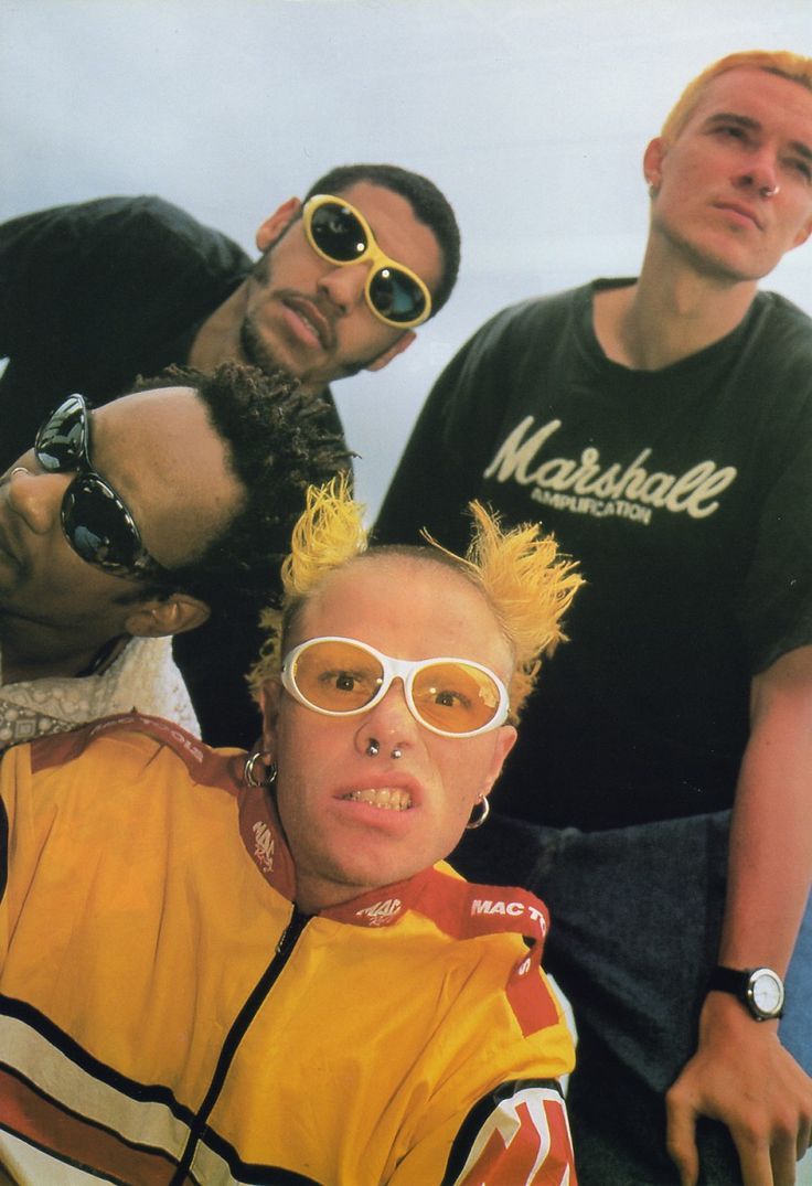 three men with yellow hair and sunglasses posing for the camera