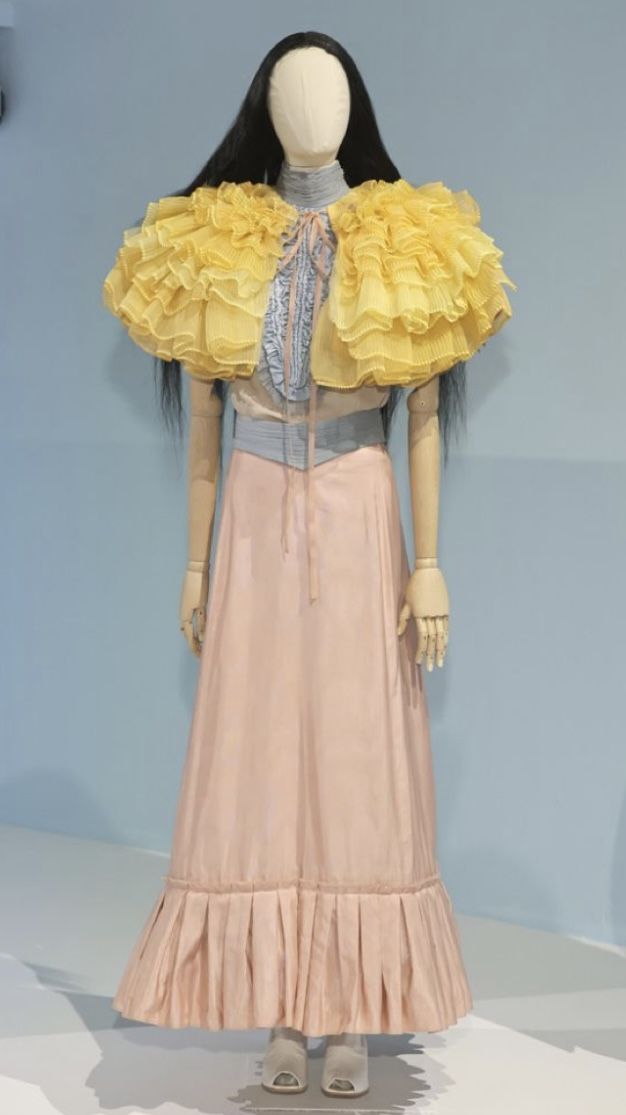 a mannequin wearing a dress with ruffles on it's shoulders