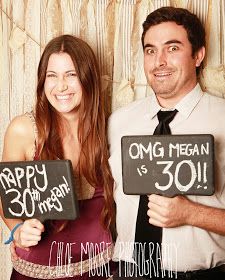 a man and woman holding up signs that say happy 30th