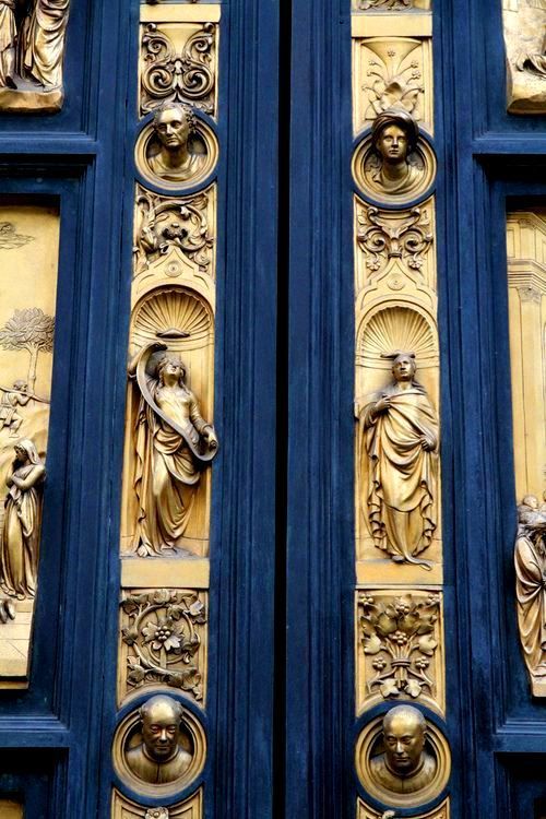 the doors are decorated with gold and blue paint on them, including angels above each door