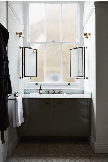 a bathroom with two sinks and a large window