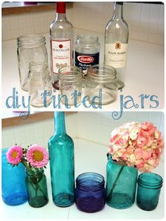 there are several different jars and vases on the counter top with flowers in them