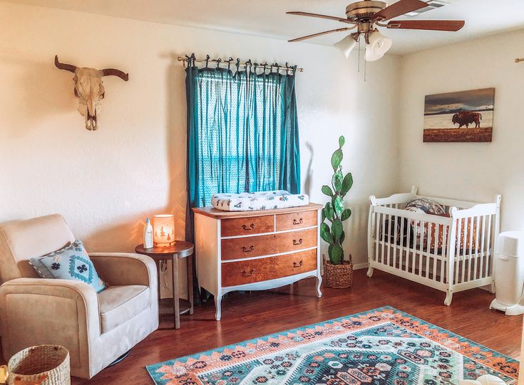 a baby's room with a crib, rocking chair and dresser