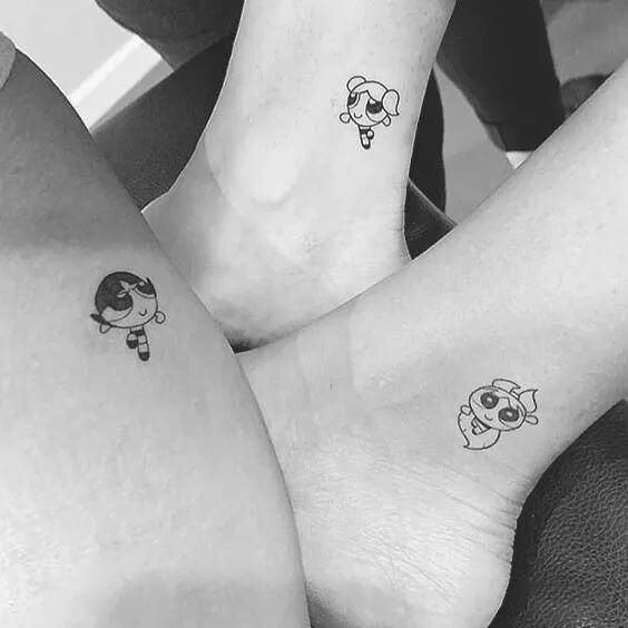 three people with matching tattoos on their legs