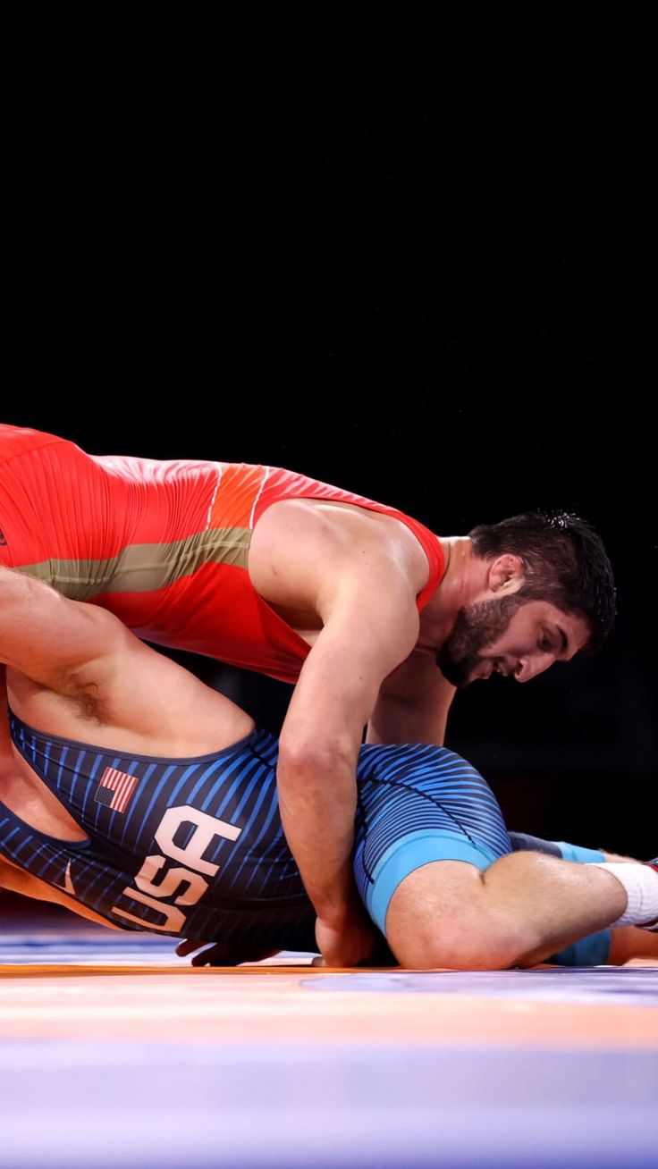 two wrestlers are wrestling in an arena