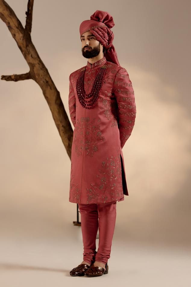 Red full sleeves sherwani in linen silk base with all over tone on tone resham work, gold zari and dabka details. Paired with full sleeves plain kurta, churidar, safa and embroidered border contrasting stole.
Components: 5
Pattern: Embroidery
Type Of Work: Resham, Zari, Dabka
Neckline: Band
Sleeve Type: Long
Fabric: Linen Silk
Color: Red
Other Details: 
Closure: 
Sherwani: Front hooks
Kurta: Front placket buttons
Note: The jewellery worn by the model is not for sale
Occasion: Groom - Aza Fashion Elegant Long Sleeve Kurta With Zari Weaving, Elegant Sherwani With Zari Weaving For Festive Occasions, Elegant Eid Sherwani With Zari Weaving, Red Bollywood Sherwani With Straight Kurta, Festive Brocade Sherwani With Naqshi Detailing, Formal Sherwani With Zari Weaving, Ceremonial Sherwani With Zari Weaving, Formal Sherwani With Zari Weaving In Traditional Drape, Red Bandhgala For Eid With Straight Kurta Shape