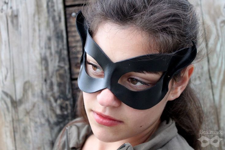 "These classic black leather cat masks are sculpted from tooling leather and painted on both sides. The color is sealed with an acrylic topcoat, and the simple shaping is comfortable and quite flattering on most faces. MEASUREMENTS + MATERIALS ✭ Measures approximately 7\" wide x 4\" high at its highest and widest points. ✭ Ties with gorgeous and durable stretch lace ribbon straps (included). ✭ Hand crafted using tooling leather, dye, paint, sealant, and quality ribbon ties. First photos courtesy Catwoman Cosplay, Superhero Masks, Pointed Ears, Half Mask, Leather Mask, Cat Mask, Disney Movie, October 25, Super Hero Costumes