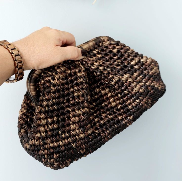 "📌 Add a touch of glamour to your everyday look with this handmade crochet bag. 📌 Knitted with shiny metallic yarn, this bag is perfect for any fashionable woman. 📌 The spacious interior can hold all of your essentials, making it a functional and stylish choice for your next night out or daily errands. 📌 The crocheted design adds a unique and handmade touch, making this bag a one-of-a-kind piece. 📌 Treat yourself or a loved one to this beautiful crochet bag today. 💡SMALL:    23 cm x 15 cm Handmade Crochet Bags, Crochet Pouch, Handmade Clutch, Brown Wedding, Wedding Clutch, Metallic Yarn, How To Start Knitting, Wedding Bag, Leather Clutch Bags