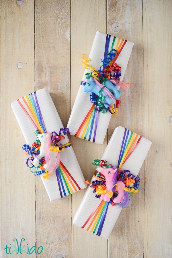 three wrapped presents with colorful ribbons on them