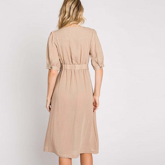 Elevate your wardrobe with our Asymmetrical Button-Down Wrapped Midi Dress, a true embodiment of timeless elegance and style. This dress offers a perfect blend of sophistication and modern flair, ensuring you'll look effortlessly chic and feel confident on any occasion. Key Features: Half-Sleeve Design: The dress features a half-sleeve with button closure, providing a touch of modesty and versatility. You can adjust the sleeves to your preference, making it suitable for various weather condition Fitted V-neck Midi Dress With Button Cuffs, Fitted Dress With Button Back For Casual Occasions, Solid Color Semi-formal Midi Dress For Fall, Casual Button-back Fitted Dress, Elegant Dresses With Button Closure, Chic Midi Dress With Fitted Waist For Daywear, A-line Midi Dress With Button Closure For Casual Wear, Beige Knee-length Semi-formal Dress, Fitted Beige Midi Dress For Semi-formal Occasions