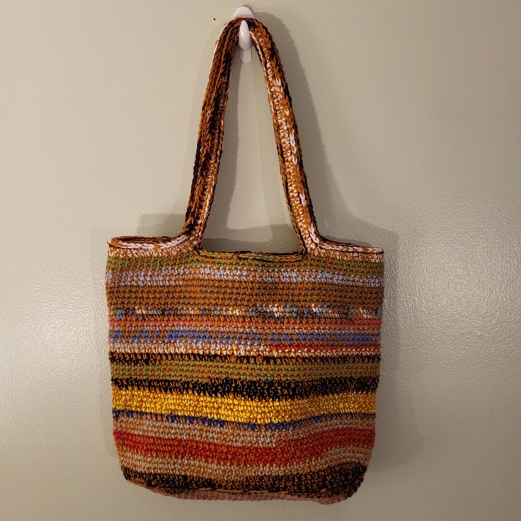 a multicolored purse hanging on the wall