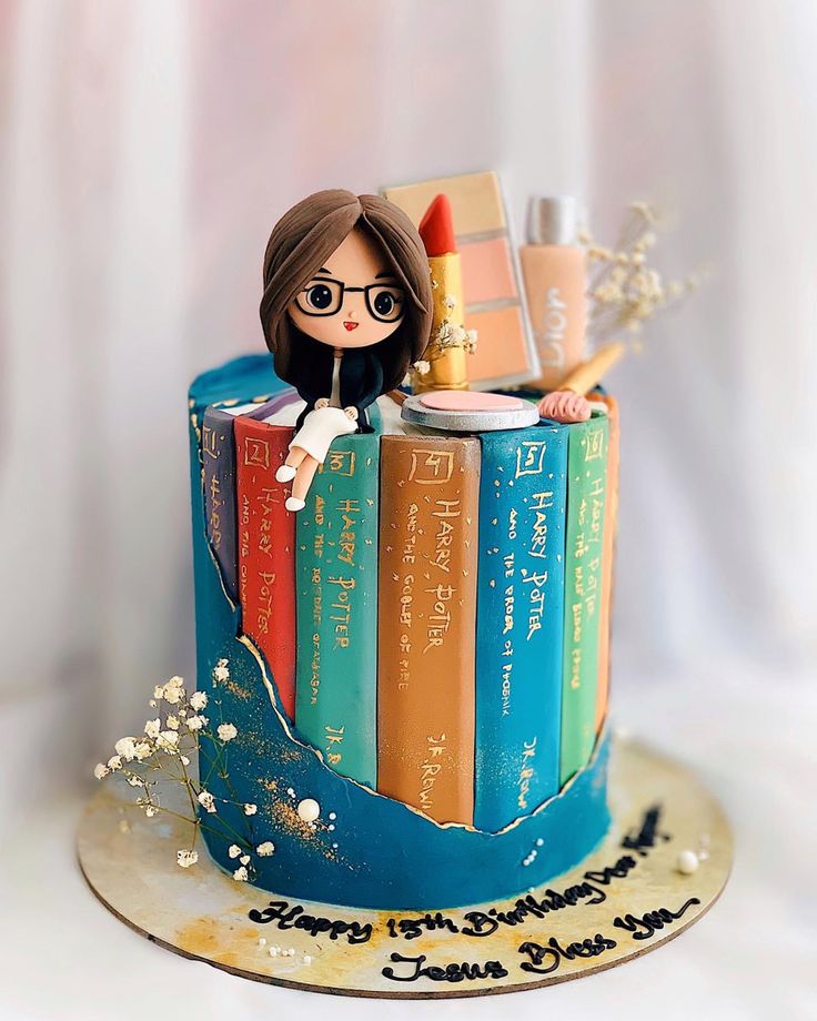 a cake decorated with books and a doll