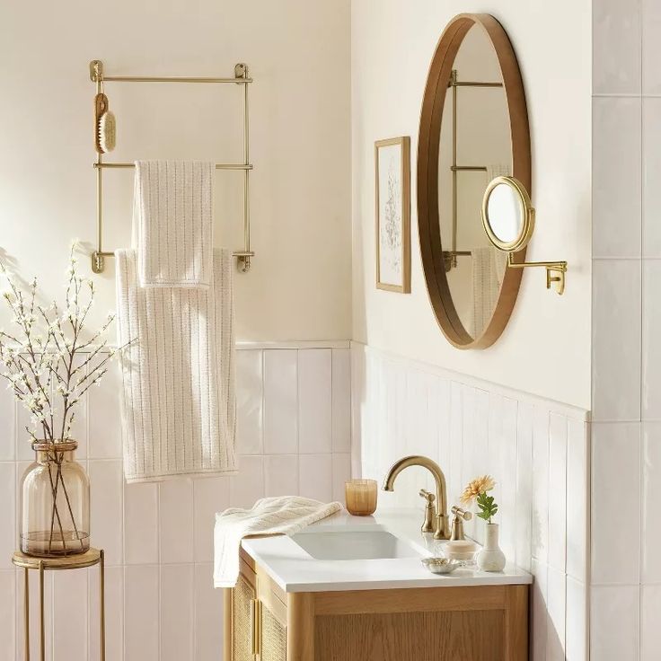 a bathroom with a sink, mirror and towel rack on the wall next to it