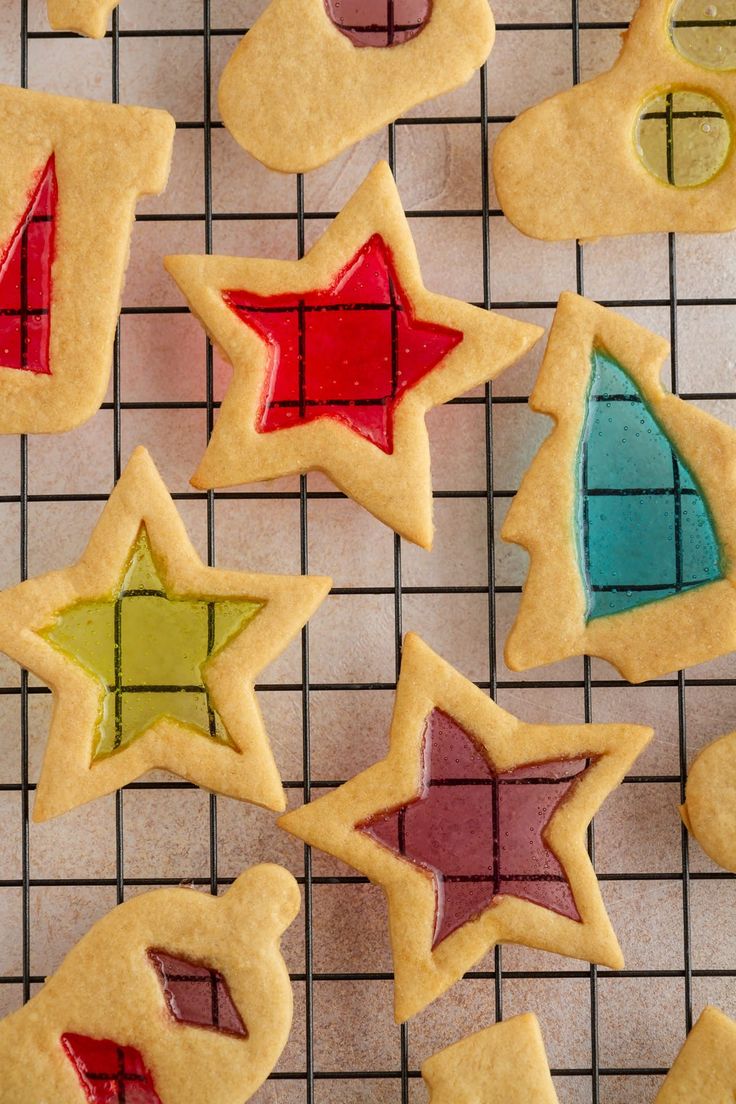 cookies decorated with different shapes and colors on a cooling rack