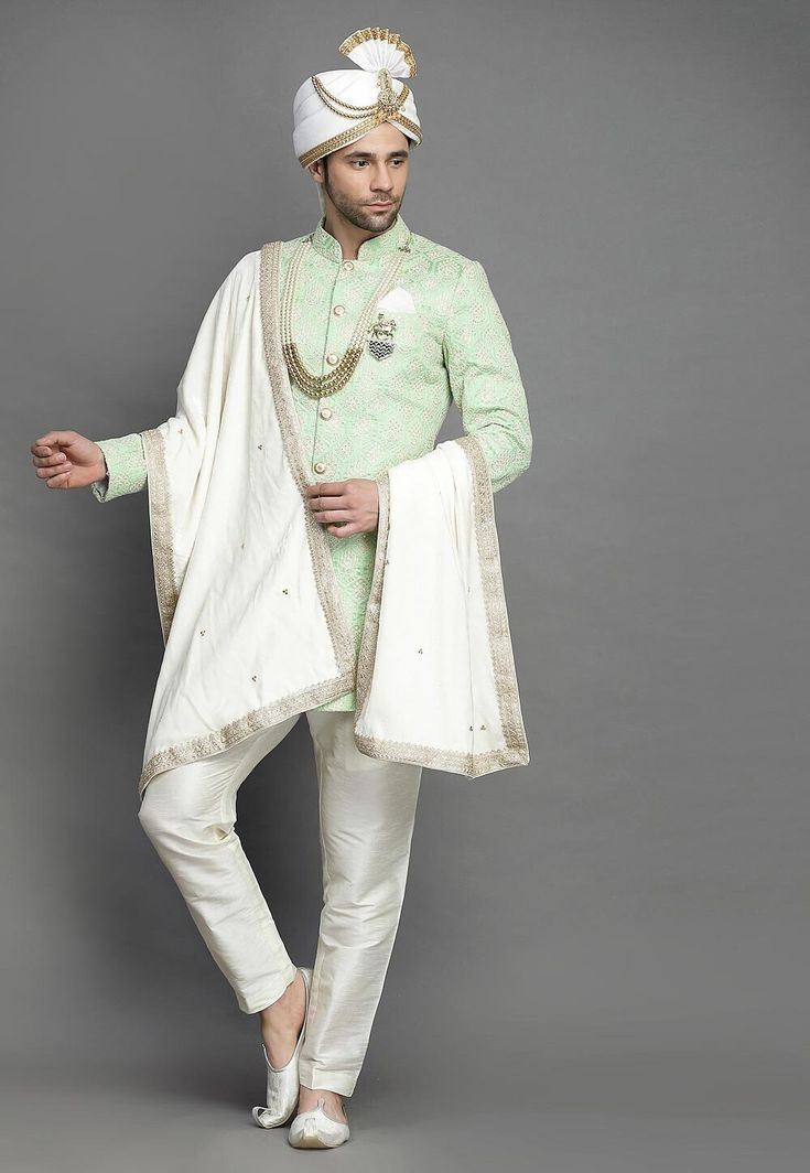 Art Silk Sherwani in Light GreenThis Readymade attire is Enhanced with Buttons and Resham Work. Crafted in Chinese Collar Neck and Full SleeveAvailable with an Art Silk Pant in Off WhiteDo note: Turban, Kanthimala, Dupatta, Brooch and Footwear shown in the image is for presentation purposes only. Half to one inch may vary in measurement. In case you want to purchase the Dupatta (WEBSITE ITEM CODE: MXX300). (Slight variation in actual color vs. image is possible) We sell all kinds of menswear. Me Anarkali Sherwani With Chikankari Embroidery In Chanderi, Traditional Chanderi Sherwani With Dabka Work, Designer Chanderi Sherwani With Traditional Drape, Traditional Dabka Work Chanderi Sherwani, Semi-stitched Embroidered Anarkali Sherwani, Anarkali Style Sherwani With Resham Embroidery In Art Silk, Ceremonial Anarkali Style Raw Silk Kurta, Festival Chanderi Sherwani With Dupatta, Festive Anarkali Sherwani With Chikankari Embroidery